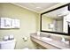 Well-lit bathroom featuring a granite countertop vanity, toilet, and a mirror above the sink at 7100 N Ocean Blvd. # 405, Myrtle Beach, SC 29572