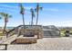 Inviting brick patio with fireplace, stairs, and picturesque ocean view with palms, perfect for relaxation at 7100 N Ocean Blvd. # 405, Myrtle Beach, SC 29572