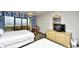 Comfortable bedroom with two queen beds and a small table with chairs near the balcony at 7100 N Ocean Blvd. # 405, Myrtle Beach, SC 29572