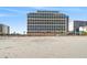 Beachfront condo building with ocean views and a sandy beach in front at 7100 N Ocean Blvd. # 405, Myrtle Beach, SC 29572