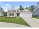 Charming single-story home with a well-manicured lawn and a two-car garage at 742 Woodside Dr., Conway, SC 29526