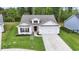 Aerial view of a well maintained single-story home with a two-car garage and green lawn at 742 Woodside Dr., Conway, SC 29526