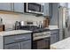 Updated kitchen with stainless steel appliances, gray cabinets, and subway tile backsplash at 742 Woodside Dr., Conway, SC 29526