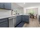 Modern kitchen with stainless dishwasher, granite counters, grey cabinets, and dining area at 742 Woodside Dr., Conway, SC 29526