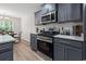 Modern kitchen featuring stainless steel appliances, grey cabinets, and granite countertops at 742 Woodside Dr., Conway, SC 29526