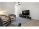 Inviting living room with high ceilings, plush grey sofas, and a large flat-screen TV at 742 Woodside Dr., Conway, SC 29526