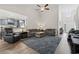 Open living room with high ceilings, ceiling fan, large windows, and view to adjacent kitchen at 742 Woodside Dr., Conway, SC 29526