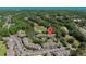 Aerial view of a building complex nestled beside a pond and golf course, surrounded by trees at 10 Logan Berry Ct. # H, Murrells Inlet, SC 29576