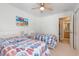 Comfortable bedroom with twin beds and ceiling fan, offering access to the bathroom with double closets at 10 Logan Berry Ct. # H, Murrells Inlet, SC 29576