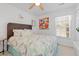 Bright bedroom with colorful floral bedding, ceiling fan, and neutral walls at 10 Logan Berry Ct. # H, Murrells Inlet, SC 29576