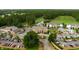 Aerial view of the community clubhouse featuring circle drive, landscaping, and ample parking at 10 Logan Berry Ct. # H, Murrells Inlet, SC 29576