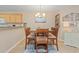 Cozy dining area with a wooden table, seating for six, and a view of the kitchen and living spaces at 10 Logan Berry Ct. # H, Murrells Inlet, SC 29576