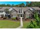 Attractive brick condo building with mature landscaping and a walkway to the entrance at 10 Logan Berry Ct. # H, Murrells Inlet, SC 29576