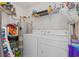 Well-organized laundry room featuring a washer, dryer, water heater, and ample shelving for storage at 10 Logan Berry Ct. # H, Murrells Inlet, SC 29576