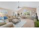 Bright living room featuring a ceiling fan, neutral colors, and comfortable seating with large windows at 10 Logan Berry Ct. # H, Murrells Inlet, SC 29576