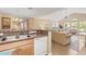 Open floor plan showcasing kitchen view to living room with vaulted ceilings and natural light at 10 Logan Berry Ct. # H, Murrells Inlet, SC 29576