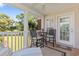 Relaxing covered patio furnished with high-top seating and a ceiling fan overlooking the landscape at 10 Logan Berry Ct. # H, Murrells Inlet, SC 29576