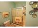 A bathroom featuring a tub and shower combination with sliding doors, towel racks, and decorative wall plates at 110 Portsmith Dr. # 8, Myrtle Beach, SC 29588