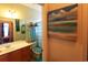 Bathroom featuring stylish decor, wooden vanity, and a peek into the Primary bedroom at 110 Portsmith Dr. # 8, Myrtle Beach, SC 29588