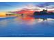 Striking beach view with a pier, featuring the colorful sunrise or sunset reflecting in the water at 110 Portsmith Dr. # 8, Myrtle Beach, SC 29588