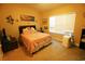 Bedroom with a bed, nightstand, window, artwork, and a portable air conditioning unit for comfortable living at 110 Portsmith Dr. # 8, Myrtle Beach, SC 29588