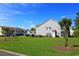 Exterior view of multi-Gathering residential building with well-maintained landscaping and a green lawn at 110 Portsmith Dr. # 8, Myrtle Beach, SC 29588