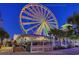 Colorful Ferris wheel at night with nearby restaurants, creating an inviting entertainment atmosphere at 110 Portsmith Dr. # 8, Myrtle Beach, SC 29588