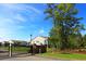 Gated entrance to the community featuring lush landscaping, a decorative brick wall, and residential buildings at 110 Portsmith Dr. # 8, Myrtle Beach, SC 29588