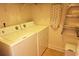 Functional laundry room with washer, dryer, ironing board, ladder, and storage space for efficient chores at 110 Portsmith Dr. # 8, Myrtle Beach, SC 29588