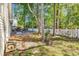 Spacious backyard with a patio area and white picket fence, surrounded by mature trees at 130 Ashton Circle, Myrtle Beach, SC 29588