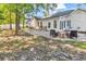 Backyard patio with outdoor seating, surrounded by mature trees and a well-maintained yard at 130 Ashton Circle, Myrtle Beach, SC 29588