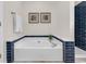 Bathroom boasts a soaking tub and walk-in shower with blue subway tile at 130 Ashton Circle, Myrtle Beach, SC 29588