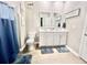 Well-lit bathroom with a double vanity and blue accents at 147 Marsh Deer Place, Surfside Beach, SC 29575