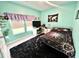 Stylish bedroom with eye-catching celestial bedding, a desk, and plenty of natural light from the window at 147 Marsh Deer Place, Surfside Beach, SC 29575