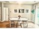 Bright dining area with a modern white table and chairs near a sliding door at 147 Marsh Deer Place, Surfside Beach, SC 29575
