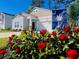 Charming home with beautiful red roses and a South Carolina state flag in the front yard at 147 Marsh Deer Place, Surfside Beach, SC 29575