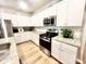 Well-equipped kitchen with white cabinets, stainless steel appliances, and bright countertops at 147 Marsh Deer Place, Surfside Beach, SC 29575