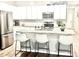 Modern kitchen with white cabinets, stainless steel appliances, and granite countertops at 147 Marsh Deer Place, Surfside Beach, SC 29575