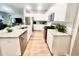 Bright kitchen features white cabinets, stainless steel appliances, and granite countertops at 147 Marsh Deer Place, Surfside Beach, SC 29575