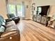 Comfortable living room with wood floors, a large sofa, and a decorative console at 147 Marsh Deer Place, Surfside Beach, SC 29575