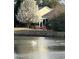 Picturesque view of a pond with a swan and blooming tree near the house at 147 Marsh Deer Place, Surfside Beach, SC 29575