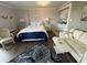 Comfortable living area with a queen bed, kitchenette, and a stylish white sofa with a starfish pillow at 2001 S Ocean Blvd. S # 511, Myrtle Beach, SC 29577