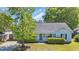 Beautiful home with a inviting front porch, green lawn, and mature trees at 202 Berkshire Dr., Myrtle Beach, SC 29588
