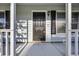 Close-up of the front porch showcasing the black front door and a glimpse of the home's exterior at 202 Berkshire Dr., Myrtle Beach, SC 29588