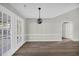 Spacious living room features stylish lighting fixture and access to bright sunroom at 202 Berkshire Dr., Myrtle Beach, SC 29588