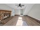 Spacious living room featuring a brick fireplace and wood-look flooring at 202 Berkshire Dr., Myrtle Beach, SC 29588