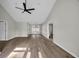 Spacious living room with new hardwood floors, a modern ceiling fan, and ample natural light creating an airy feel at 202 Berkshire Dr., Myrtle Beach, SC 29588