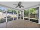 Relaxing sunroom with tile floors surrounded by windows offering backyard views at 202 Berkshire Dr., Myrtle Beach, SC 29588