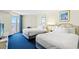Bright bedroom featuring two beds with balcony access overlooking the ocean at 2711 S Ocean Blvd. # 621, North Myrtle Beach, SC 29582