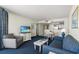 Comfortable living room with a sofa, chair, TV, and dining table at 2711 S Ocean Blvd. # 621, North Myrtle Beach, SC 29582